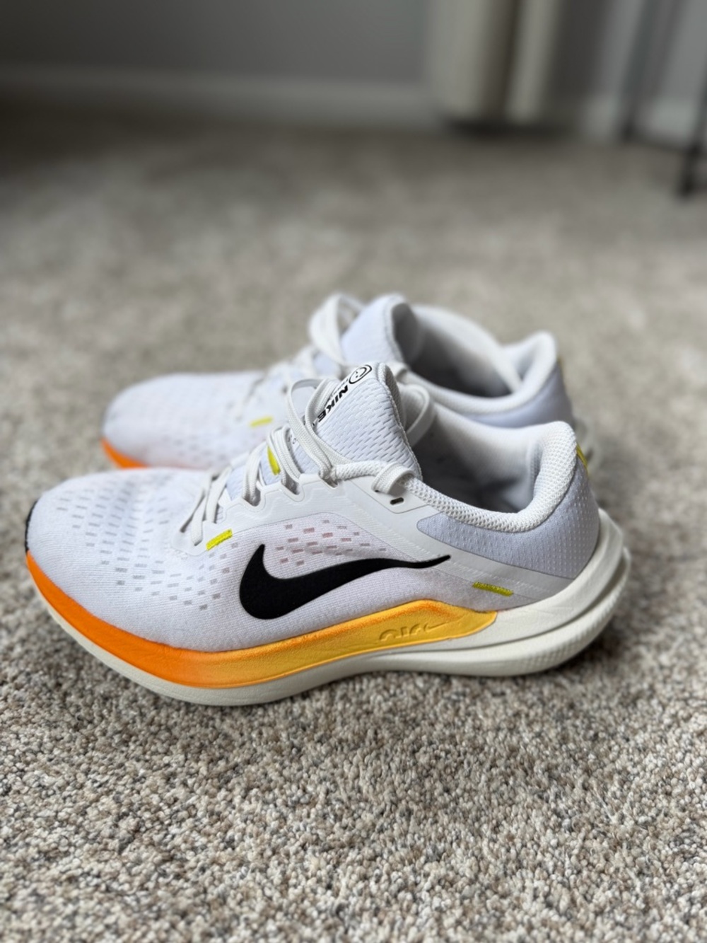 Nike White Running Sneakers with Black Swoosh and Orange-Yellow Accent